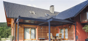 wood sided home with tile roof