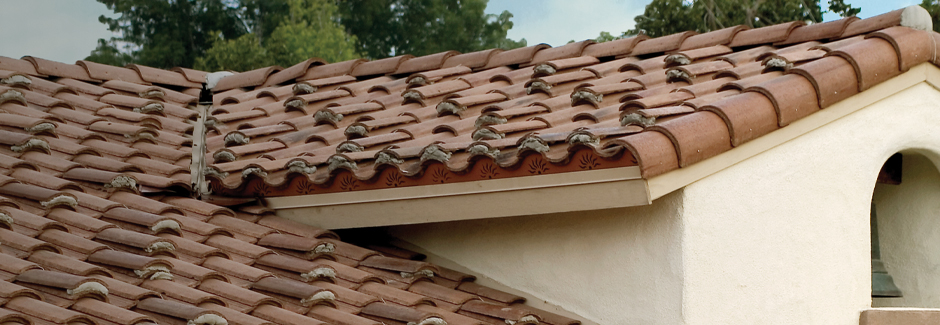 a rust colored tile roof on a southwestern style home