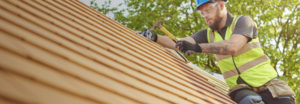 man working on a tile roof